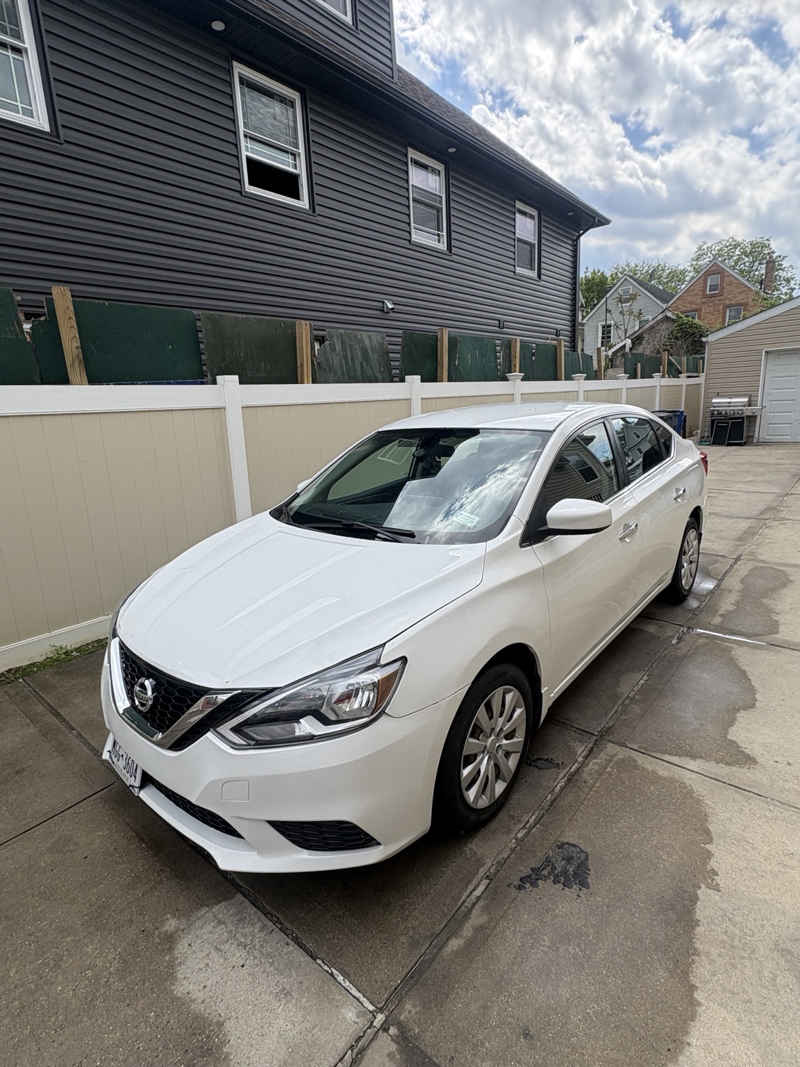 White Nissan Sentra parked outdoors